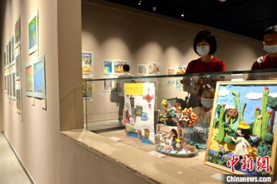 圖為家長帶著孩子參觀展覽。呂明 攝