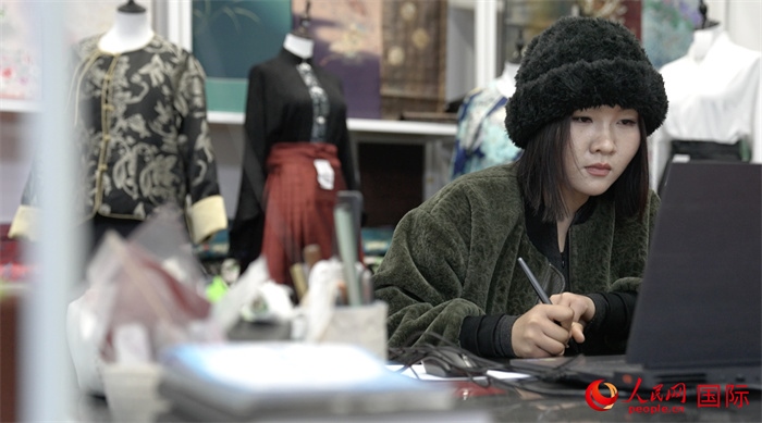 1月23日，在山東省菏澤市曹縣有愛云倉直播基地，張子晨正在設(shè)計漢服。 人民網(wǎng)記者 袁蒙攝