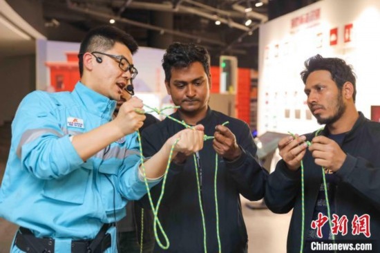 5月9日，工作人員指導(dǎo)留學(xué)生學(xué)習(xí)打繩結(jié)。張鷹 攝