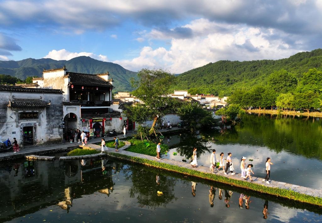 2024年7月7日，游客在安徽省黃山市黟縣宏村游玩。新華社記者杜宇攝