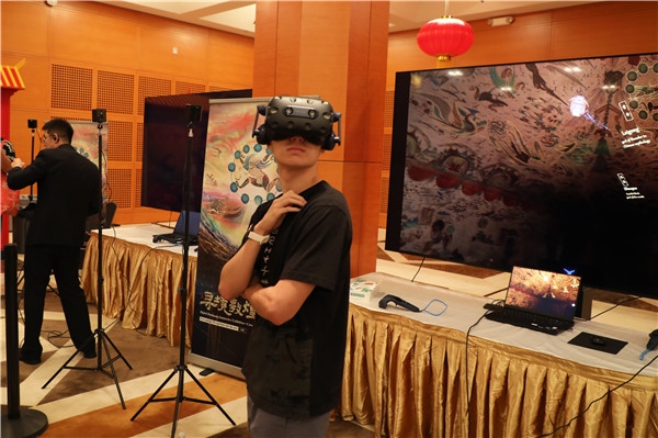 1、在本次活動的展覽現(xiàn)場，敦煌研究院與騰訊展示了“數(shù)字藏經(jīng)洞”和“尋境敦煌”等創(chuàng)新互動產(chǎn)品。圖為當(dāng)?shù)孛癖娡ㄟ^VR虛擬游覽洞窟。 人民網(wǎng)記者 李志偉攝